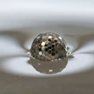 What looks like a floating disco ball is actually a ‘liquid marble’ formed from a water droplet coated in hexagonal plastic particles