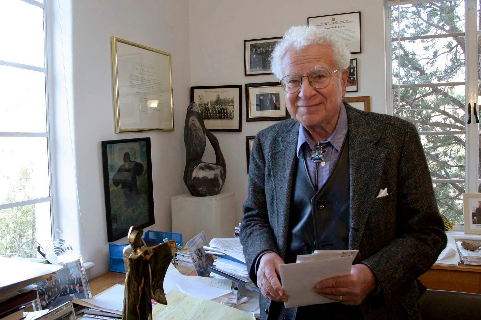Murray Gell-Mann in an office
