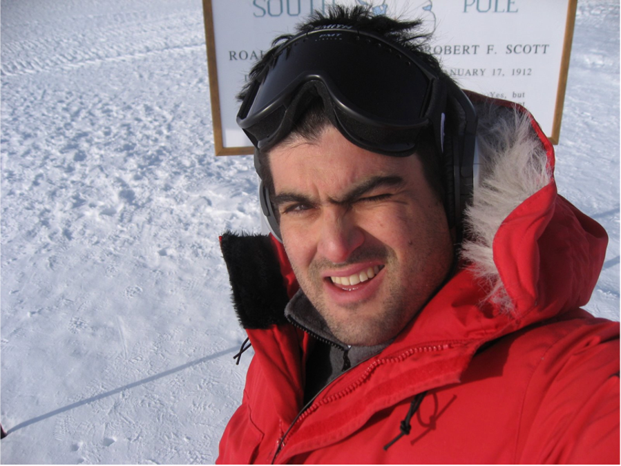 Brian Keating squinting one eye, while standing in snow