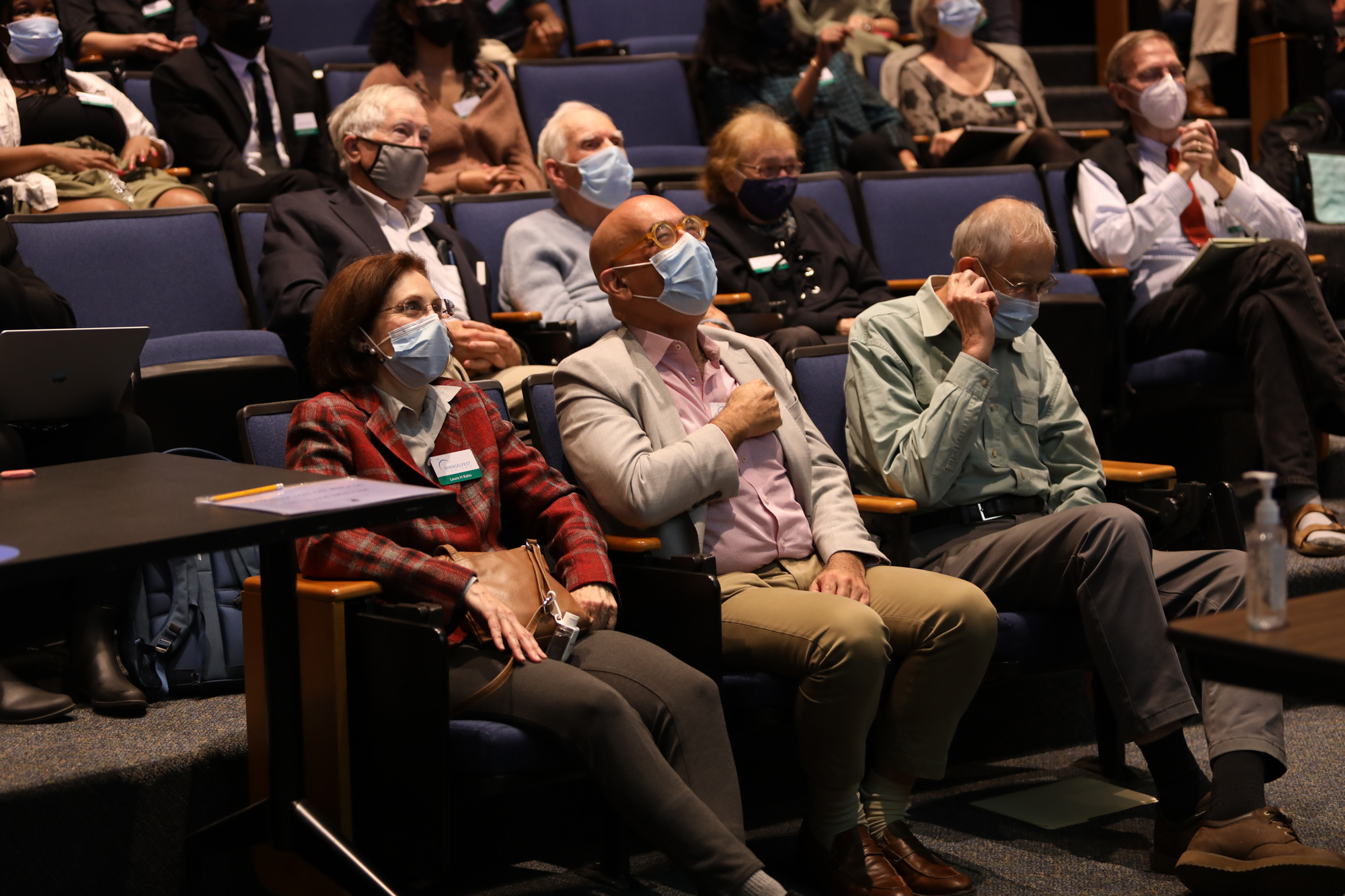 A photograph of David Spergel amongst other people in seats in an auditorium.