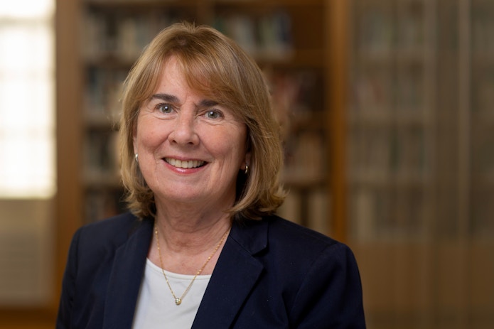 A portrait photo of Jill Pipher in front of bookshelves.