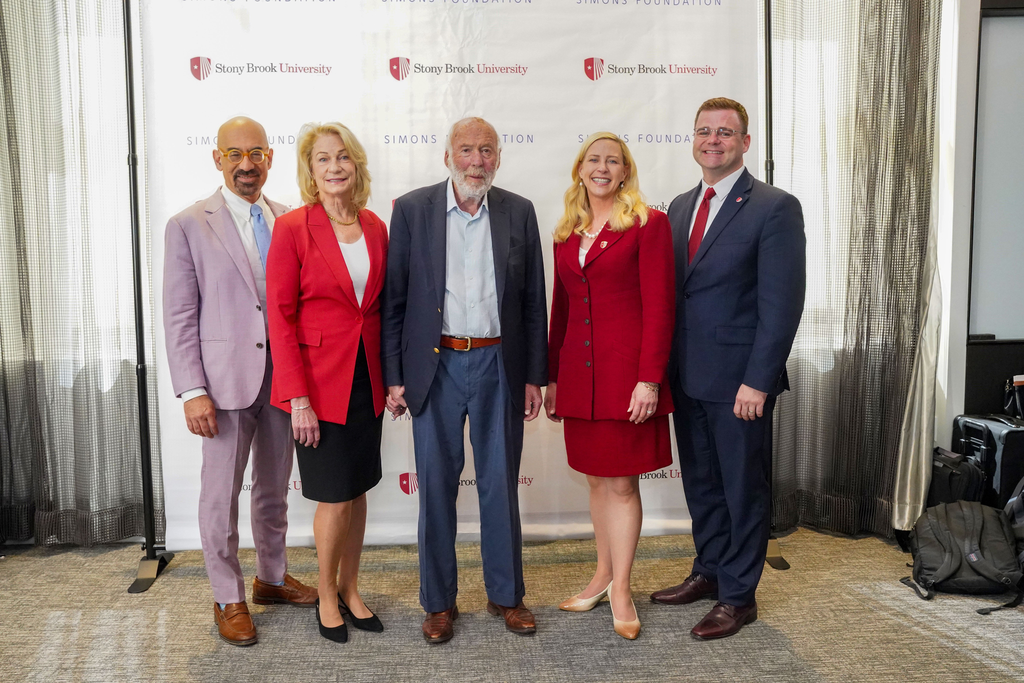 Marilyn Simons, Stony Brook University President Maurie McInnis, Jim Simons and Simons Foundation President David Spergel toast the announcement of the $500 million gift.
