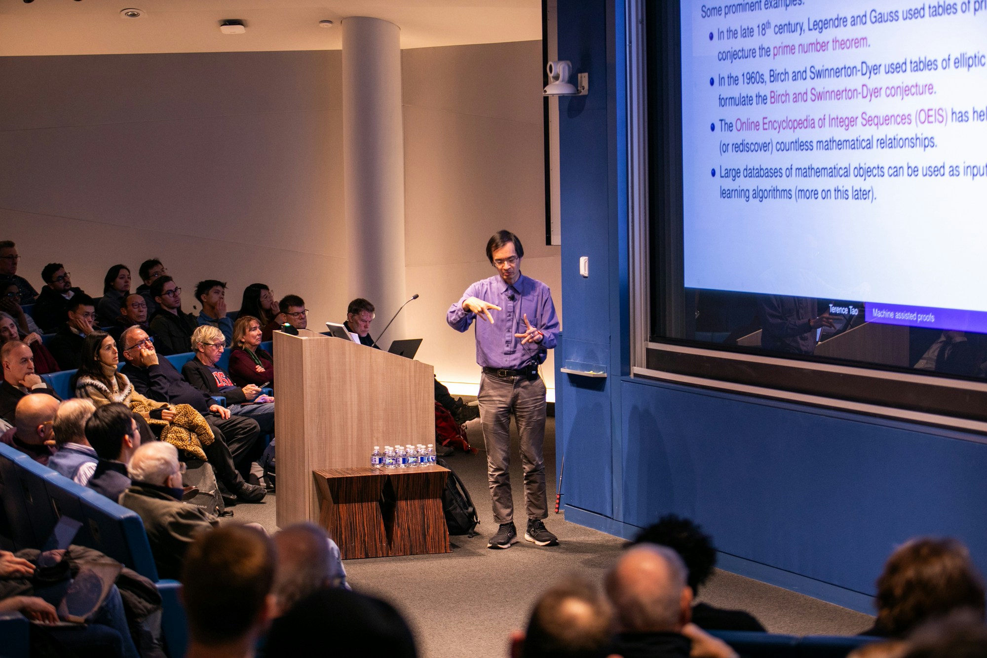 Terrence Tao giving a lecture in an auditorium.