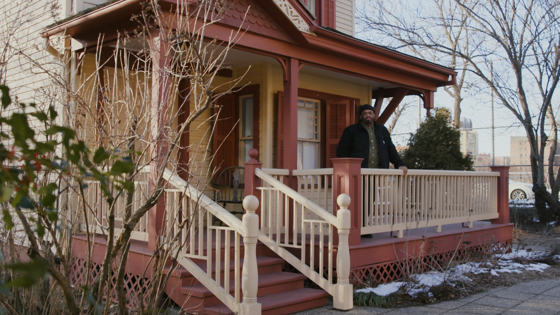 Shane Colman, lead educator at Lewis Latimer House, stands on the front porch of the Lewis Latimer House Museum.