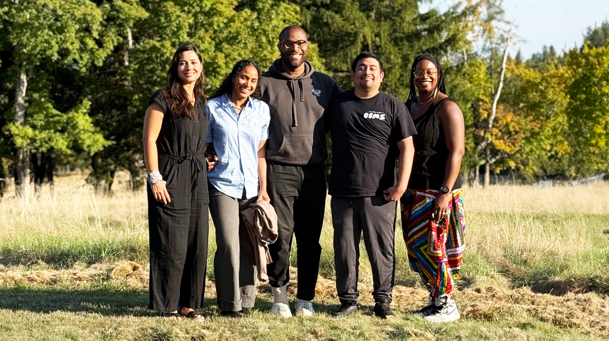 A photo of the five recipients of the Sandbox Fellowship, standing in a field.