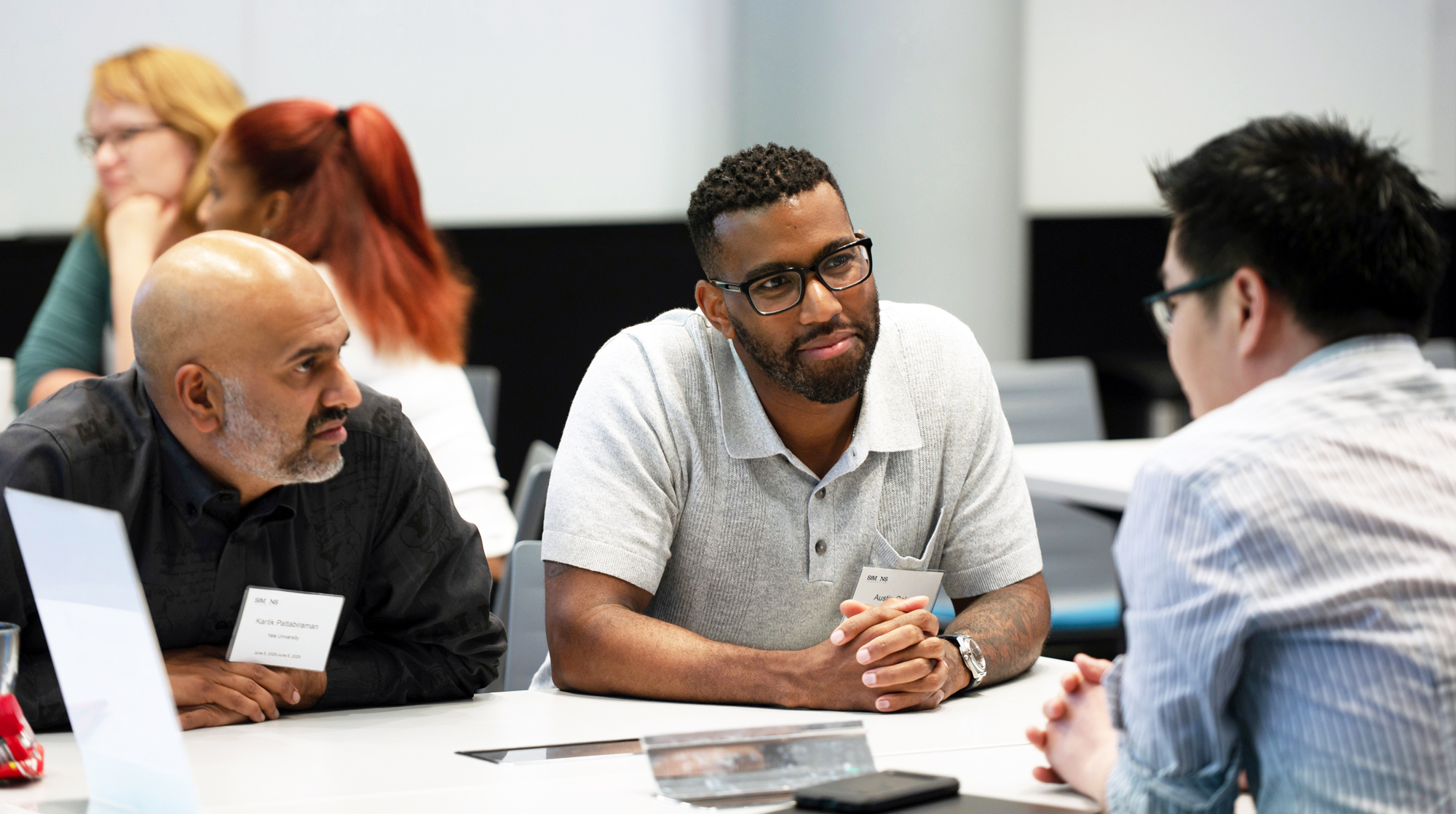 Scientists in a discussion at a table.