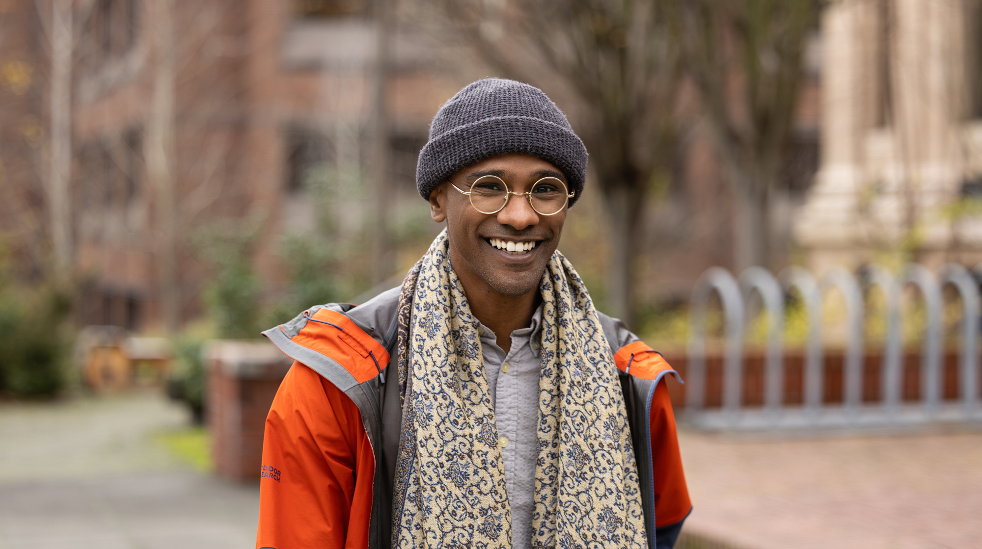 Portrait of smiling Sama Ahmed walking outside the University of Washington.