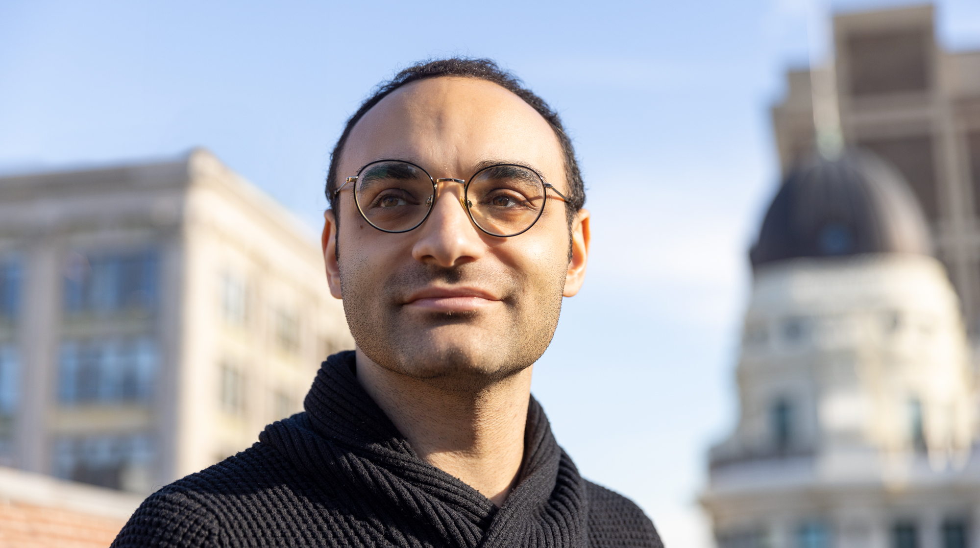 Adrian Bayer on the roof of the Simons Foundation offices, looking towards the sky.