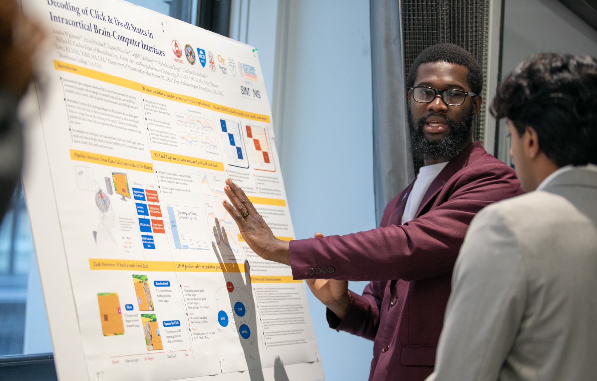 Aniaba N'Guessan presenting his poster at the SURFiN Symposium 2025.