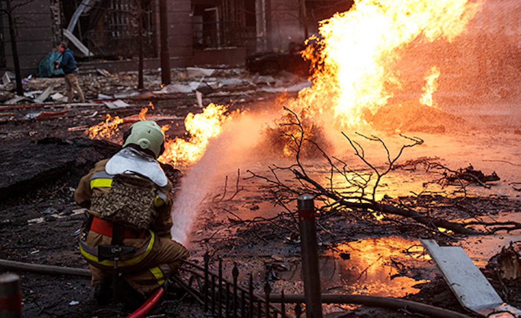 A firefighter battles a blaze in the aftermath of a Russian missile attack.