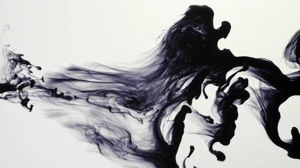 Droplet of ink squirted into water showing vortices and turbulence