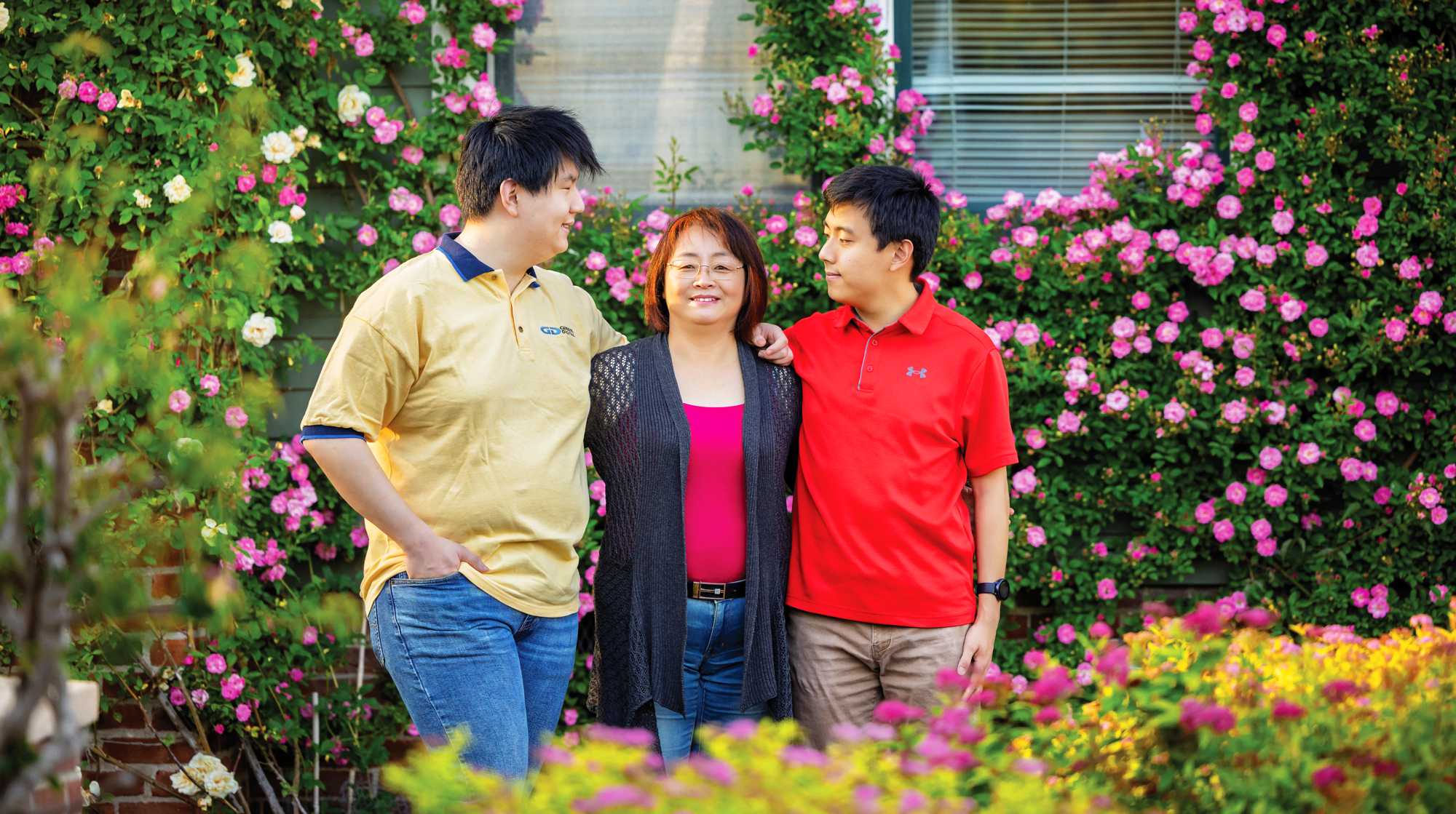 Photo of three people with trees behind them.