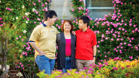 Photo of three people with trees behind them.