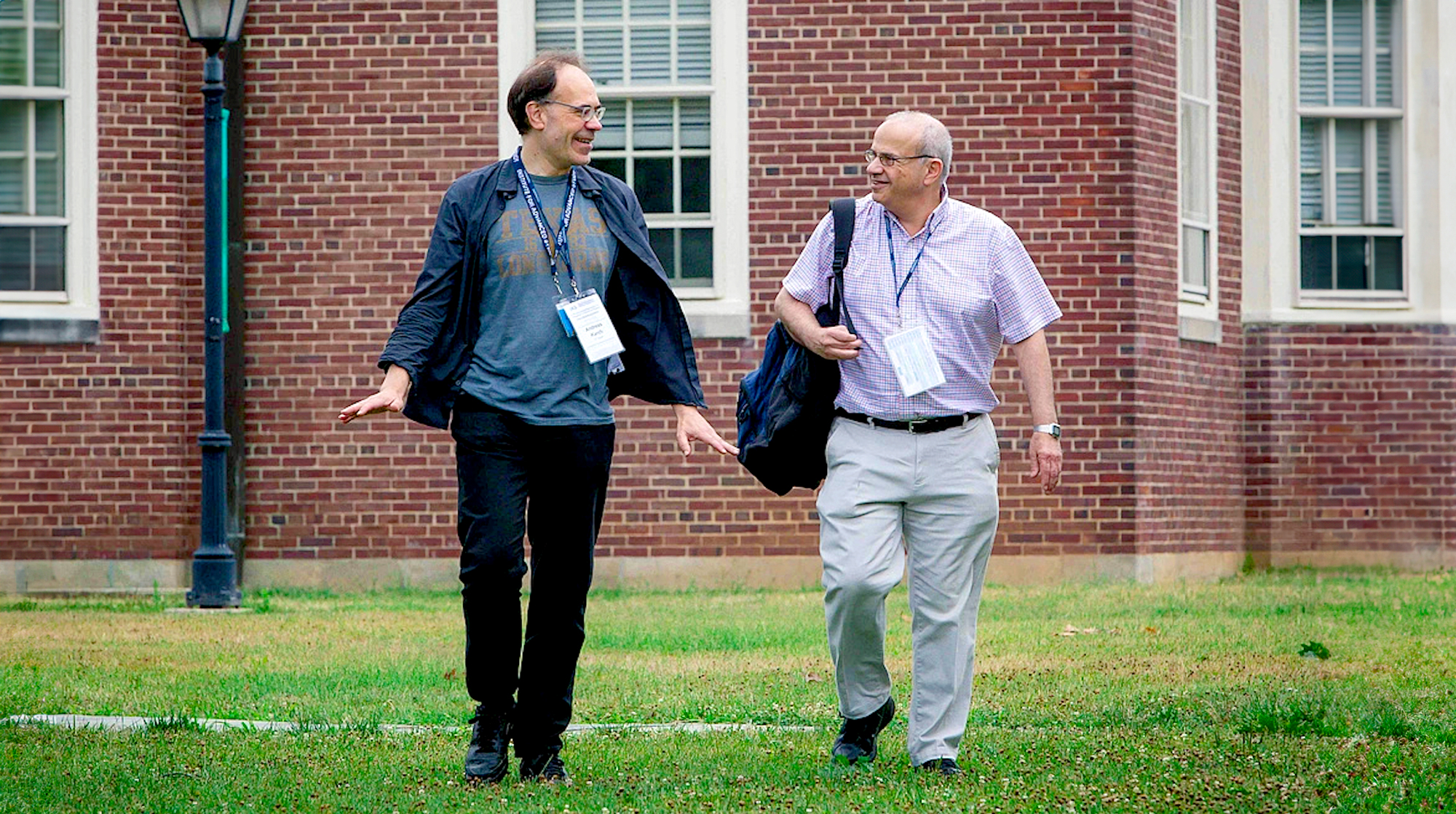 A photo of two men walking at the Institute for Advanced Study campus.