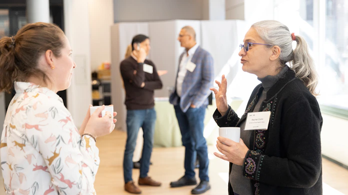 People talking during the break during the Pivot meeting.