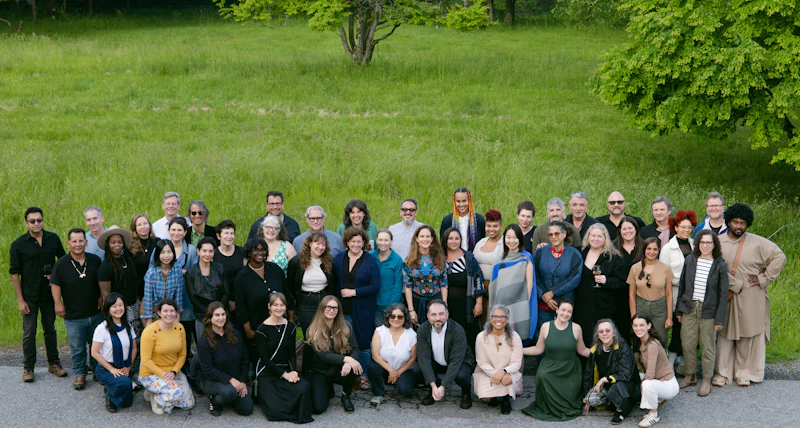 Group of people smiling outdoors.