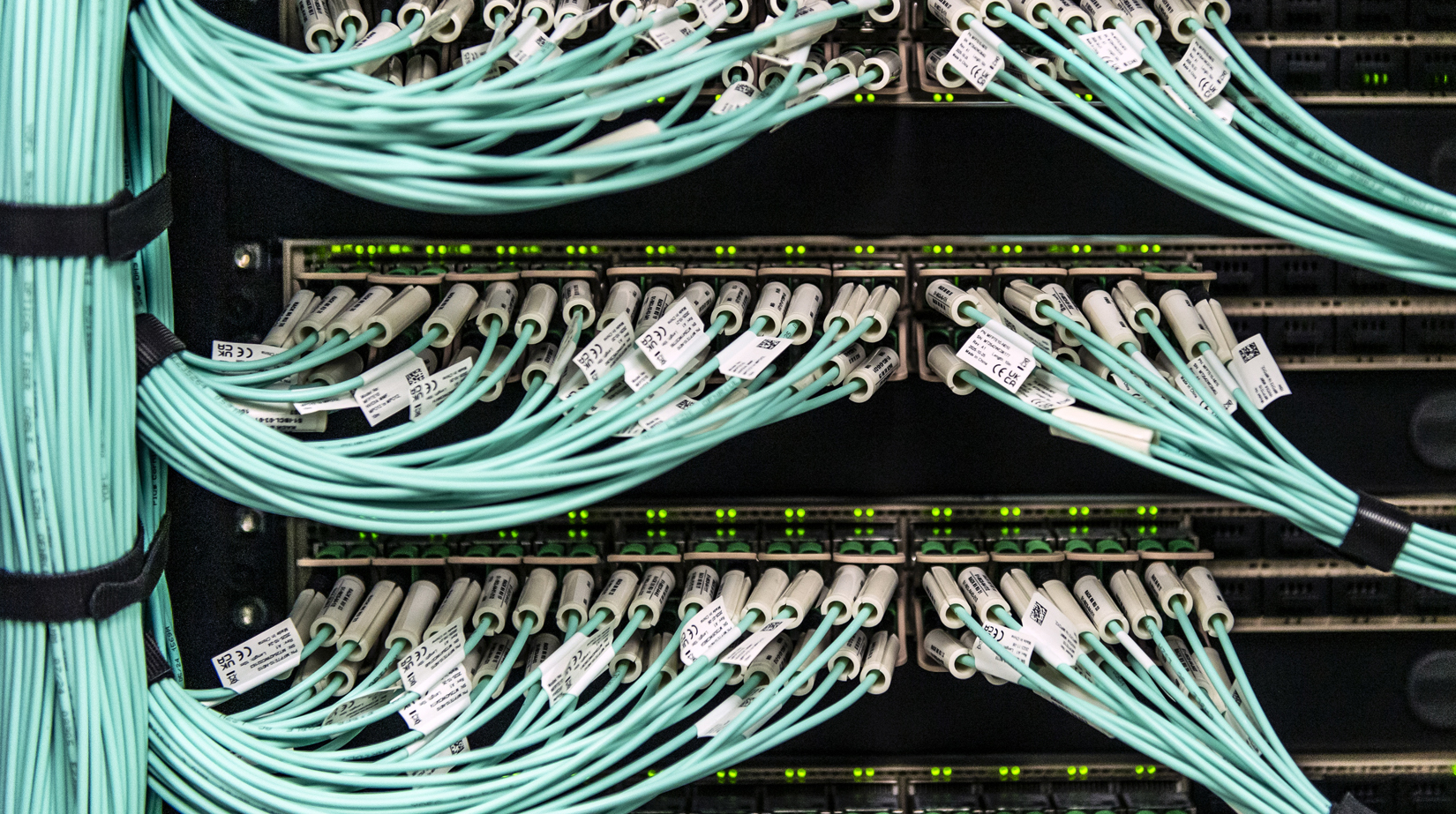 Photo of Empire AI servers with numerous cables and wires visible.