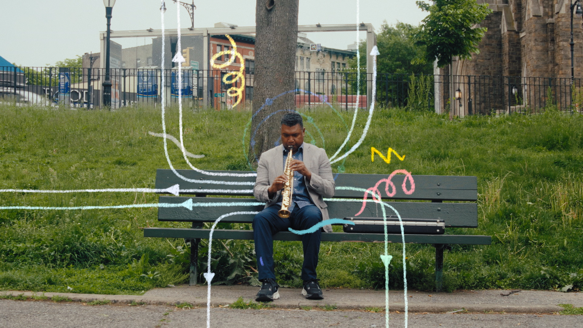 A man in a suit plays a saxophone on a park bench, surrounded by colorful, hand-drawn arrows and squiggles overlaying the photo.