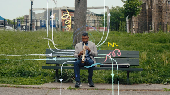 A man in a suit plays a saxophone on a park bench, surrounded by colorful, hand-drawn arrows and squiggles overlaying the photo.