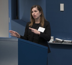 Front view of Genevieve Konopka giving a presentation at a research meeting