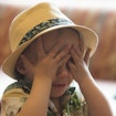 Image of child covering its eyes