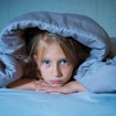 Image of girl under blanket
