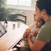 Mother and son using digital table for communicating with family doctor online from home. Woman getting a diagnosis for her sick son via video chat with digital doctor.