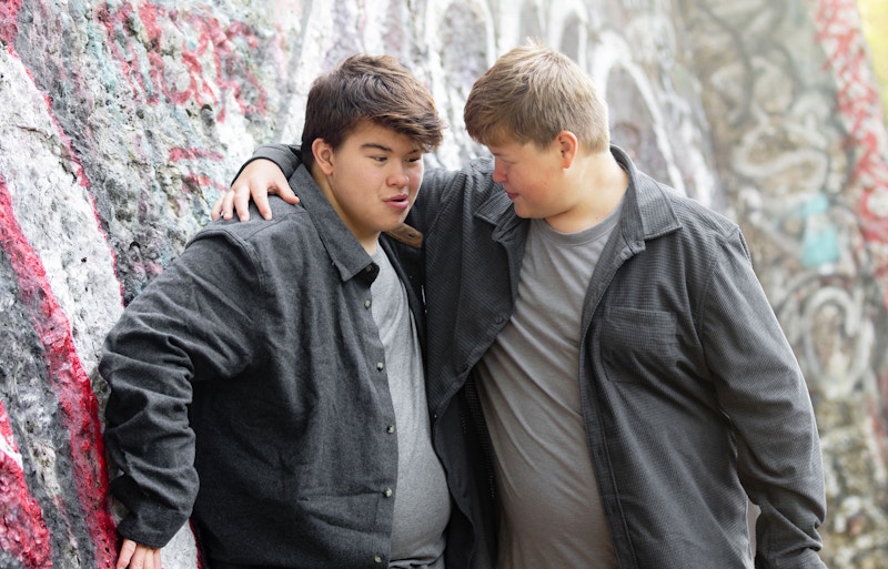 Photo of two brothers hugging each other.