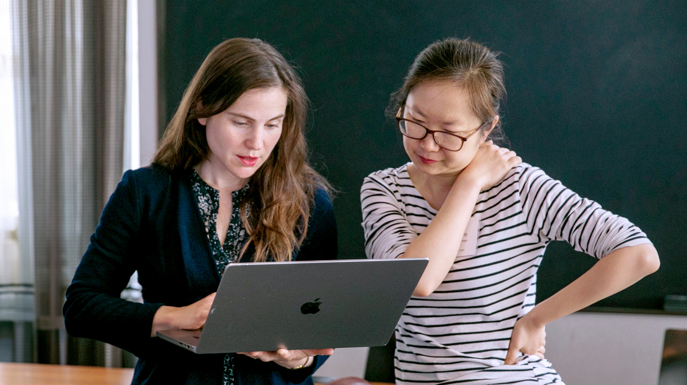 Fellows-to-Faculty awardees speaking with each other.