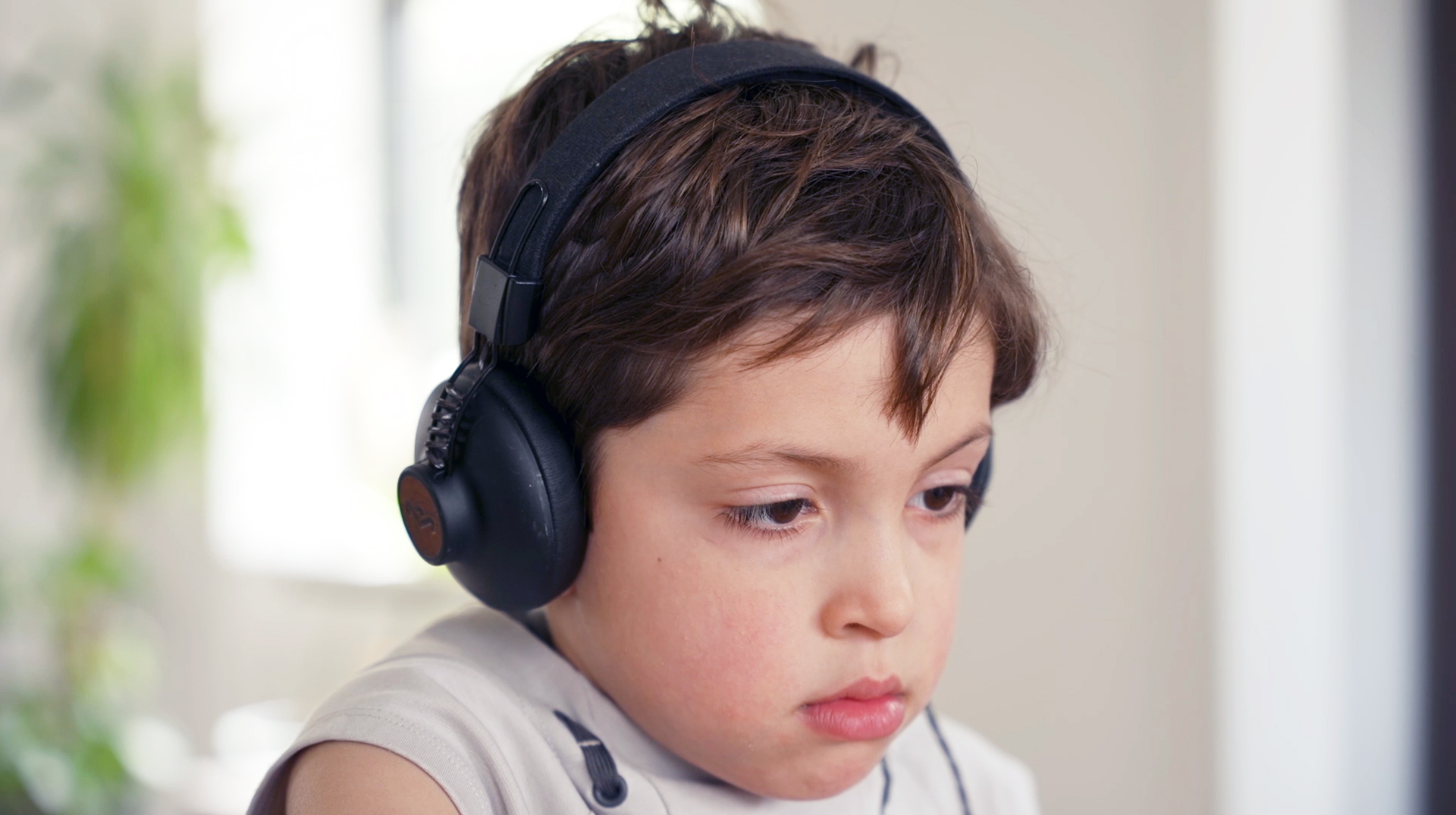 A photo of a boy using the smartphone AI app, BlinkLab, designed to support clinicians in the assessment of autism.